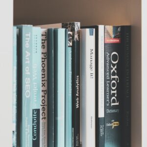 books on brown wooden shelf